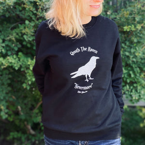 This black crewneck sweater contains a white silhouette of a raven in the centre of the graphic.  At the top are the words "Quoth the Raven" and at the bottom "Nevermore."  Edgar Allan Poe.  