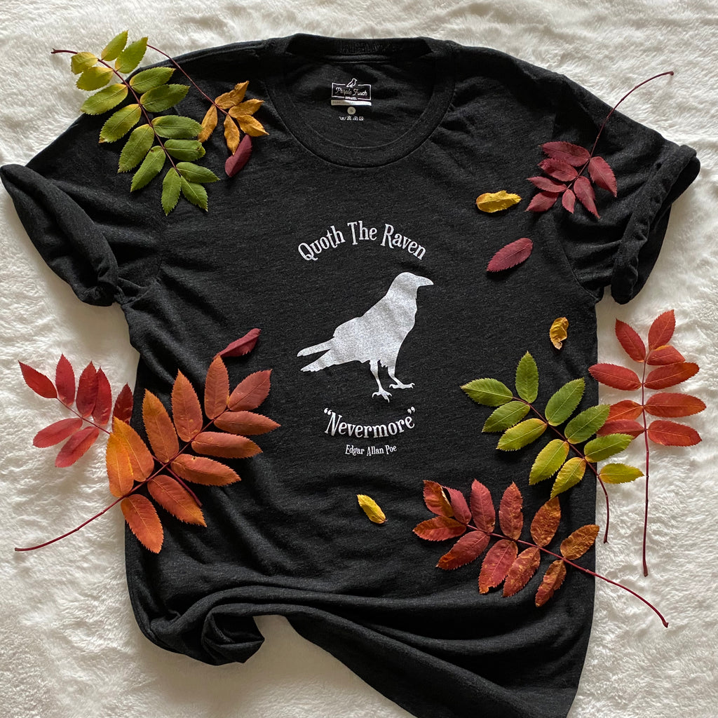 This charcoal black t-shirt has a white silhouette of a raven in the centre of the graphic. At the top are the words "Quoth the Raven" and at the bottom "Nevermore." Edgar Allan Poe.