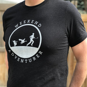 This black t-shirt contains a white silhouette of a male golfer being chased by two Canadian geese.