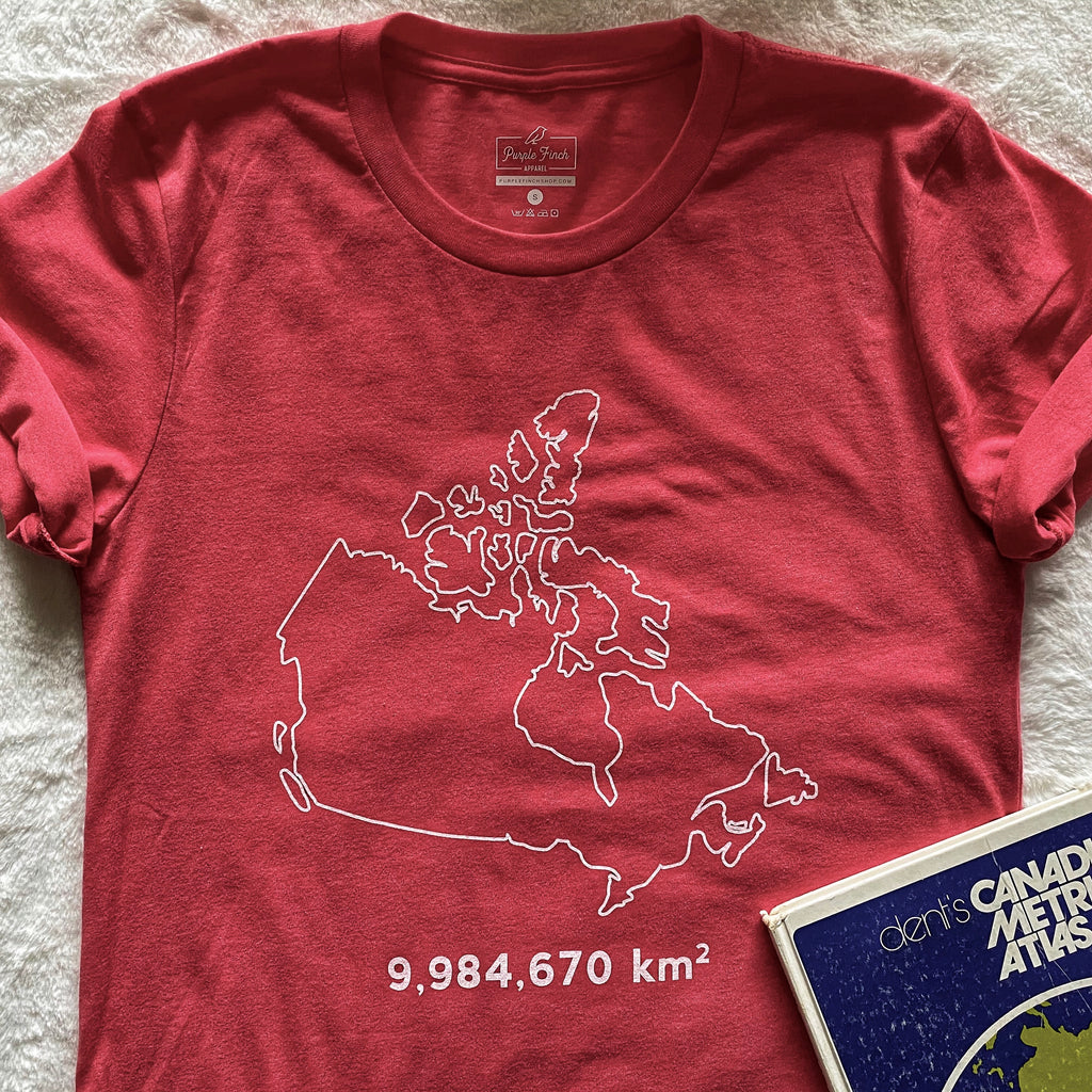 A picture of a heather red t-shirt with the outline of Canada and the number 9,984,670 underneath, as that is the number of square kilometres in Canada. 