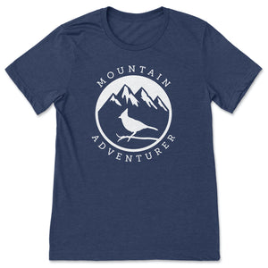 This navy t-shirt contains a white silhouette of a Steller's Jay perched on a branch against a backdrop of mountains with snowy peaks.  