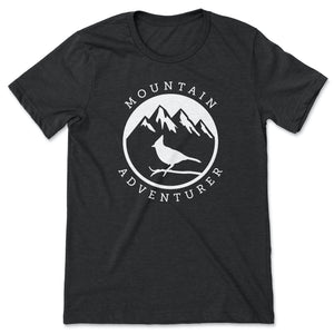 This black t-shirt contains a white silhouette of a Steller's Jay perched on a branch against a backdrop of mountains with snowy peaks.  