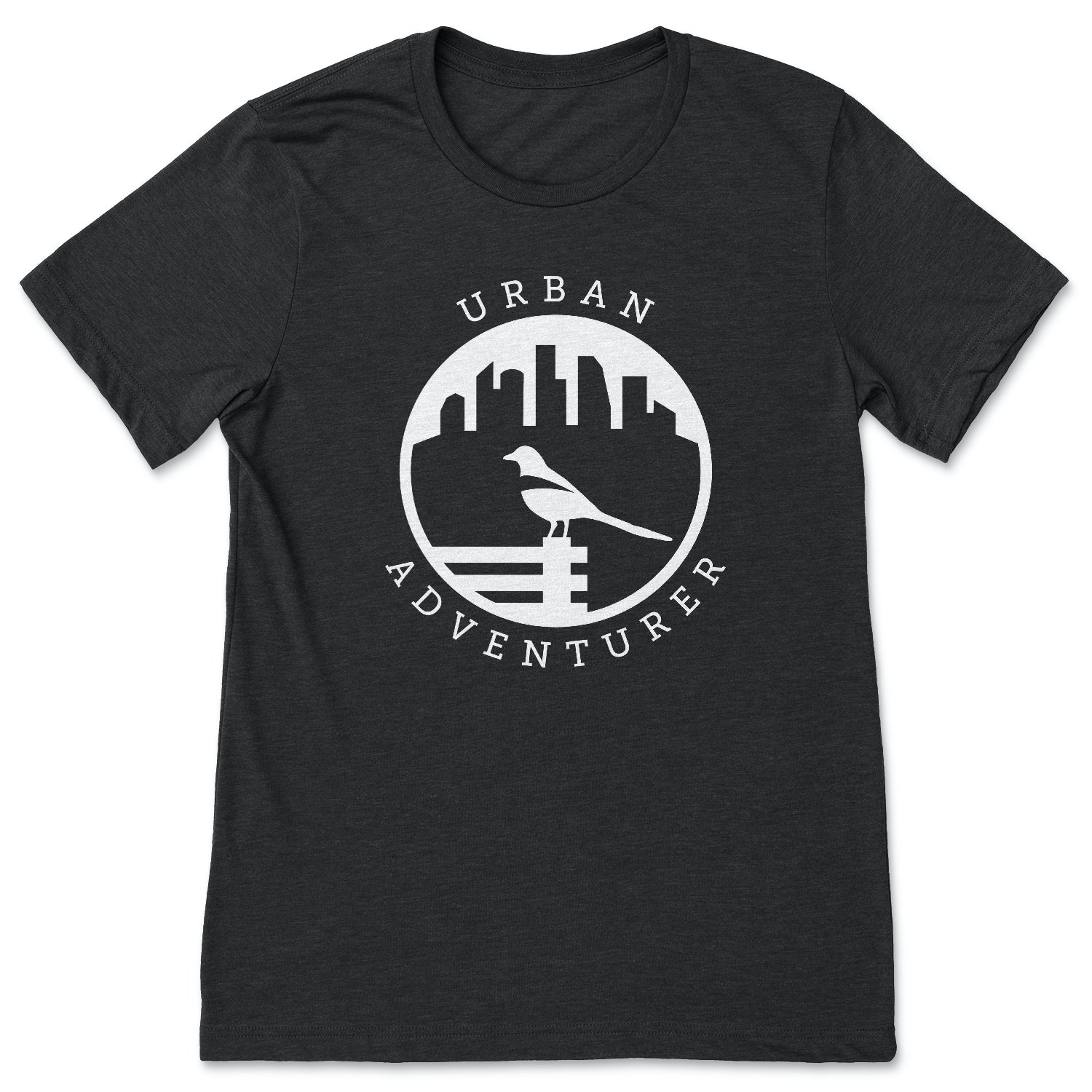 This black t-shirt contains a white silhouette of a magpie perched on a bench.  In the background is a city skyline.  